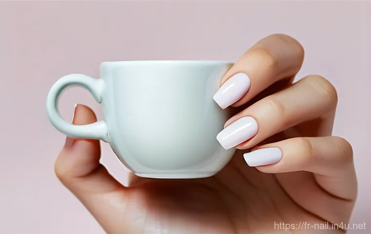 봄 네일 디자인과 컬러 추천 - **Prompt 1: Spring Pastel Elegance with Abstract Floral Nail Art**
    "A close-up of a woman's hand...