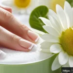 네일 클리너와 리무버 차이 - A close-up, high-resolution image of a well-manicured hand with natural nails being gently cleaned u...